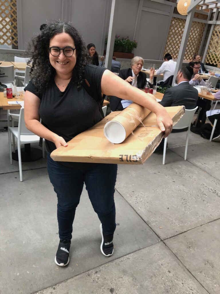 Jessica Lanan's editor Emily Feinberg holding boxes with the original art